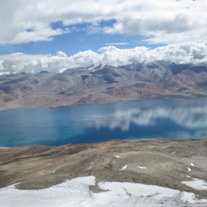 Climbing above base cap of Mentok Kangri into the snow slopes