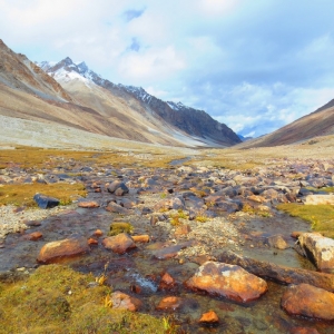 nubra valley trek, sitting next to a stream